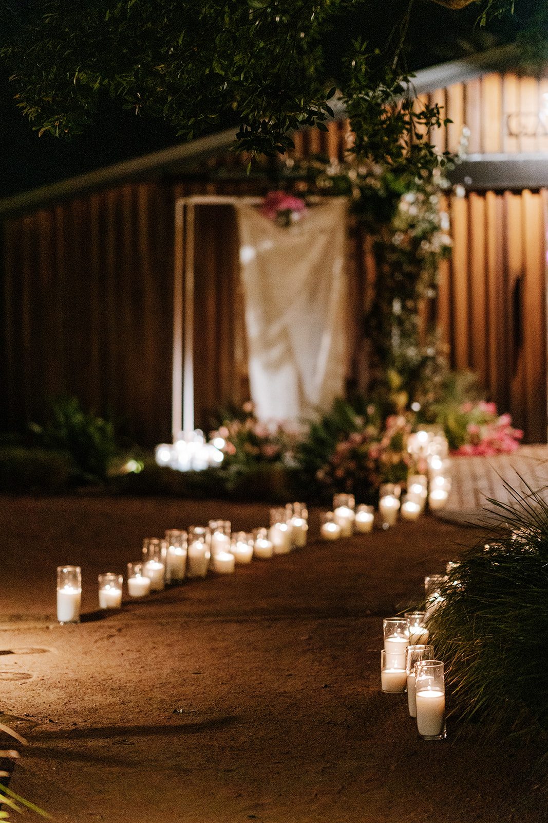 Candlelit wedding aisle lined with candles