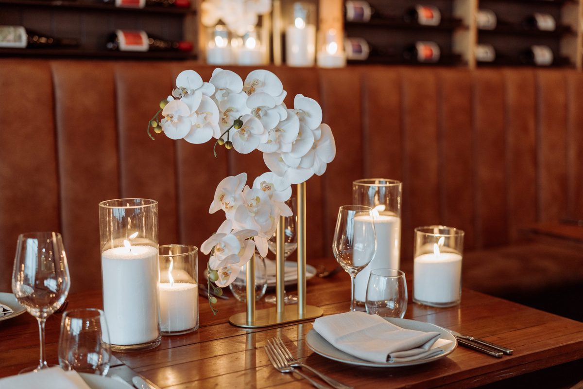 Candles in glass at a place setting